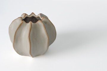 Ordinary cheap ceramic vase made in the shape of a bud. Simple form. On a white background