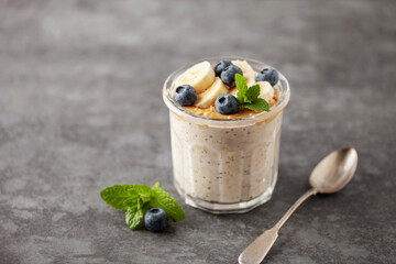 Healthy diet breakfast. Overnight oatmeal with chia seeds, bananas, peanut butter and blueberry in...