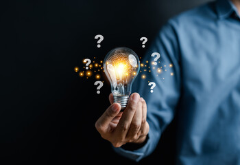 Businessman hand holding light bulb with brain into smart, creative, idea thinking to innovation...