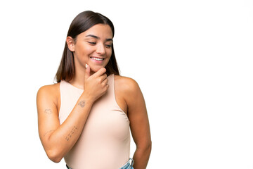 Fototapeta premium Young caucasian woman isolated on green chroma background looking to the side and smiling