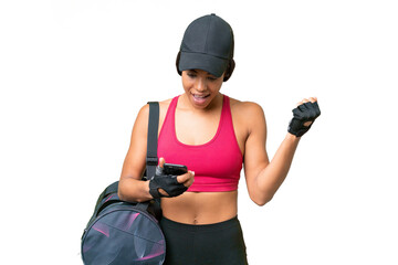 Young sport African american woman with sport bag over isolated background surprised and sending a message