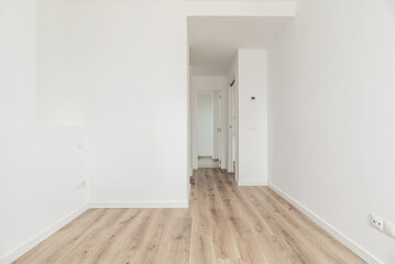 An empty bedroom with an en-suite bathroom