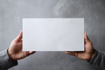 a man's hand confidently grasps a blank mockup card against a sleek gray backdrop, ready to make a memorable statement. AI Generated