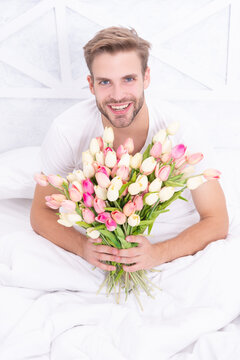 image of romantic man with march tulips bouquet. romantic man with march tulips. romantic man