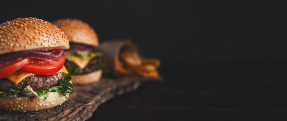 two mouth-watering, delicious homemade burger used to chop beef. on the wooden table. - 606549757