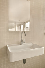 a sink and mirror in a small bathroom with white tiles on the wall behind it, there is a window