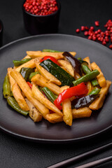 Delicious fried potatoes with bell peppers, asparagus beans, salt and spices