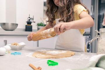 Obraz na płótnie Canvas Baking Dreams: Little Girl Bringing Cookie Dough to Life with a Rolling Pin