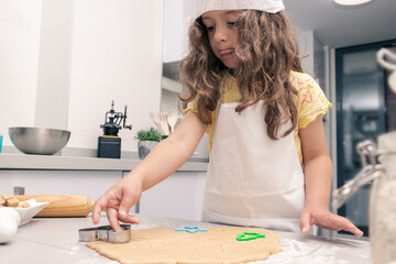 Pastry Perfection: Young Baker Cutting Dough into Irresistible Treats