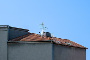 Roof with terrestrial antenna and satellite antenna and chimney