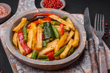 Delicious fried potatoes with bell peppers, asparagus beans, salt and spices