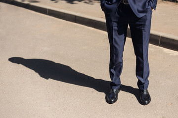 man in a business suit and black patent leather shoes. beautiful shadow - 606561118