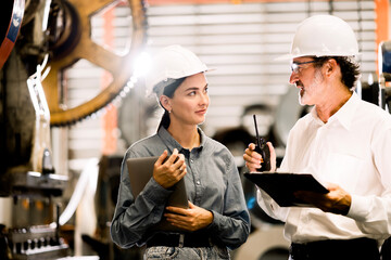 Two professional engineer,worker,technician use clipboard discuss work, walk in steel metal...