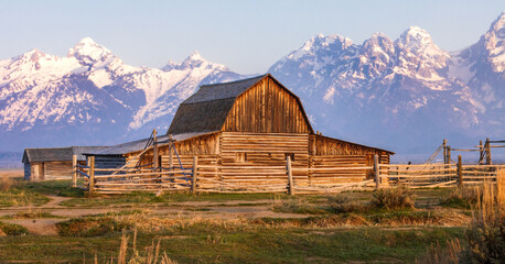 Sunrise from The Mormon Row Historic barn in front of a snow-capped Grand Teton mountain range
