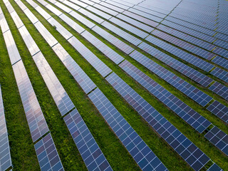 big solar power station on a green meadow aerial view