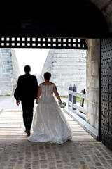bride and groom walking in medieval fortress