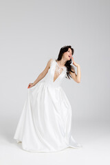 Fototapeta na wymiar Beautiful bride in elegant white dress. isolated on white background. full length
