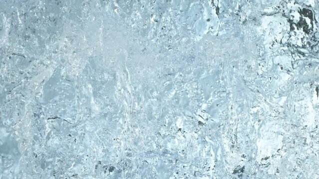 Super Slow Motion Shot of Clear Water Wave Splash on Light Blue Background at 1000fps.