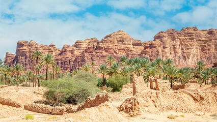 Al Ula ruined old town street with palms and rocks int the background, Saudi Arabia