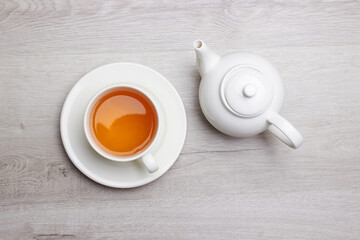 Obraz na płótnie Canvas Cup of Tea on a light wooden background