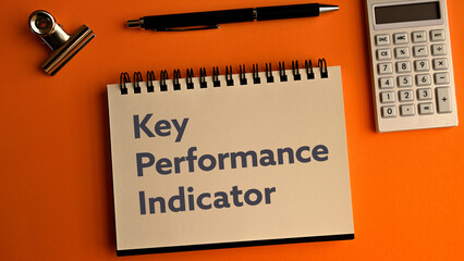 There is notebook with the word Key Performance Indicator. It is an abbreviation for Key Performance Indicator as eye-catching image.