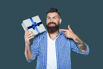mature bearded man point finger on present box