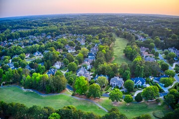 Aerial panoramic view of an upscale subdivision shot during golden hour - obrazy, fototapety, plakaty