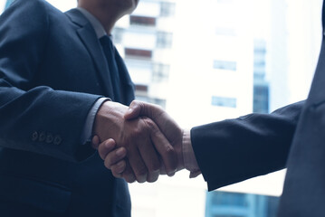 Businessmen making handshake in the city,  business etiquette, congratulation, merger and...