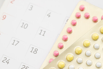 Contraceptive control pills on date of calendar background. health care and medicine concept