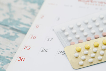 Contraceptive control pills on date of calendar background. health care and medicine concept