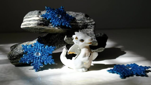 Chinese new year decorations with  cute figurine baby dragon and glittering  snowflake. Atmospheric mood