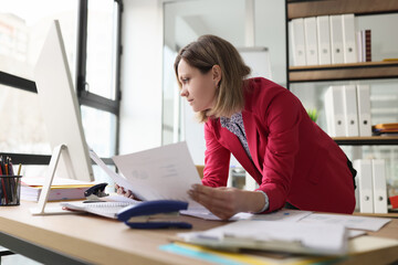 Attentive manager checking accounting papers with statistics