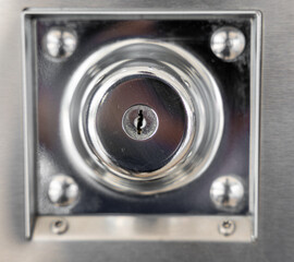 Keyholes. close up detail modern round metal key hole steel door, security safety protect