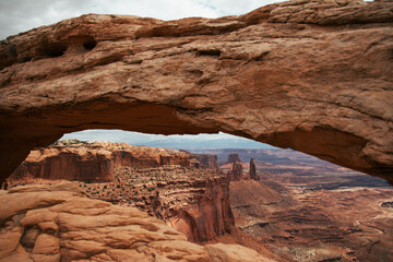 Looking through Mesa Arch in Canyonlands National Park. A unique landscape through an arch.