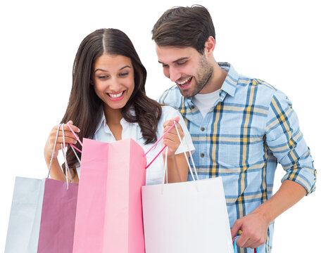 Digital png photo of happy biracial couple holding shopping bags on transparent background
