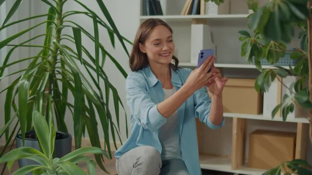 Smiling Young Woman Takes Care of Indoor Plants, Cozy Home Interior, Woman Photographing Home Flowers, Woman Photographing a Room, Photos of Flowers, Woman Taking a Selfie With Flowers, Flower Lover