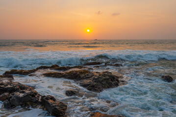 Fototapeta premium A long exposure image of waves on the stones near Galle town in Sri Lanka