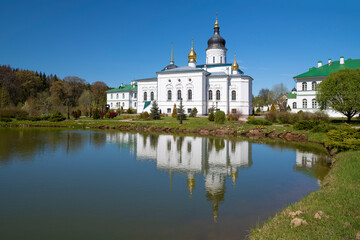 Fototapeta na wymiar View of the Cathedral of the Three Saints (1574) with reflection in the Spaso-Eleazarovsky Monastery on a sunny May day. Pskov region, Russia
