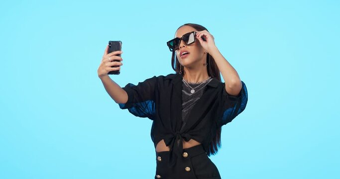 Selfie, fashion sunglasses and woman in studio isolated on blue background mockup. Self photography, beauty or stylish female person, influencer and profile picture, social media or cool aesthetic.