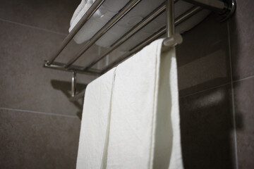 Clean white towel on a hanger prepared to use.