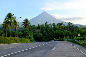 Beautiful road view of Mayon volcano in Albay Province, Philippines with white smoke. © sulit.photos