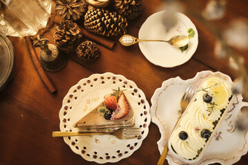 a table topped with plates of food and a slice of cake, a still life by Annabel Kidston, shutterstock contest winner, rococo, whimsical, rococo, repeating pattern