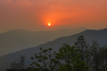 Beautiful sunrise in mountains of Himalayas, Hee Barmiok village of Sikkim, India. Great Himalayan mountain peaks in the background.