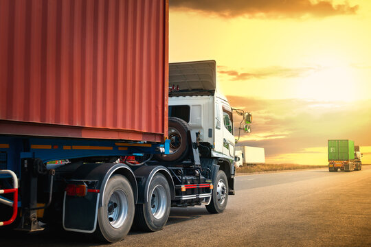 Semi Trailer Trucks Driving On Highway Road With The Sunset. Shipping Container Trucks. Commercial Truck Transport, Delivery Express. Diesel Lorry Tractor. Freight Trucks Logistics, Cargo Transport.