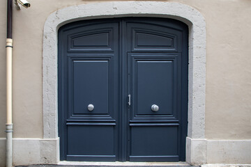 Fototapeta na wymiar grey wooden arch door double of street restored house entrance facade classic gate