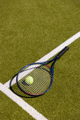 High angle view of tennis racket and ball by marking on grassy land at tennis court