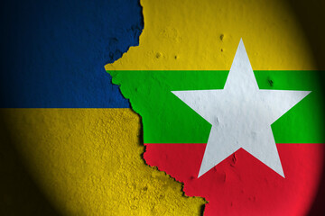 Ukraine flag and Myanmar flag painting on wall. Ukraine vs Myanmar.