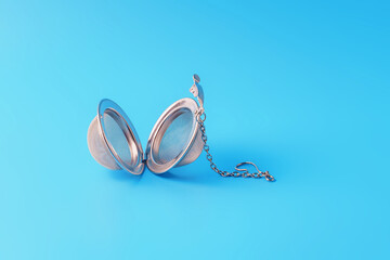 New metal tea strainer on a blue background