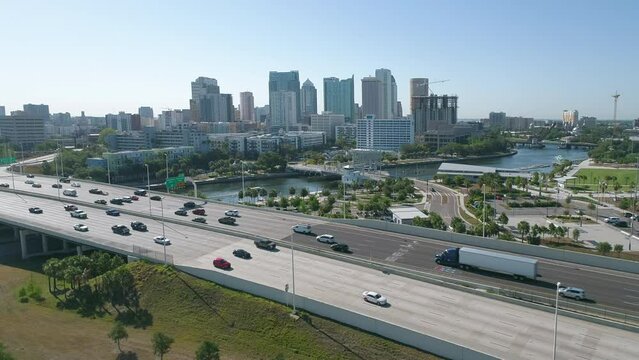 Aerial drone shot of Downtown Tampa skyline with busy morning vehicle traffic on I-275
