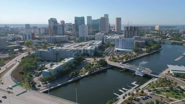 Aerial drone shot of Downtown Tampa skyline pulling away and ascending to reveal skyline and vista during morning traffic